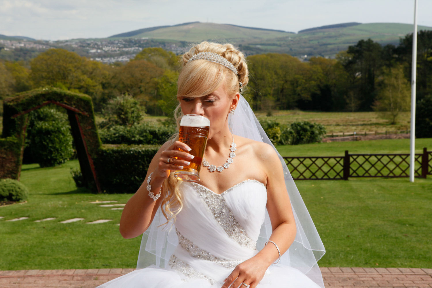 Bride drinks a pint of beer in Wales
